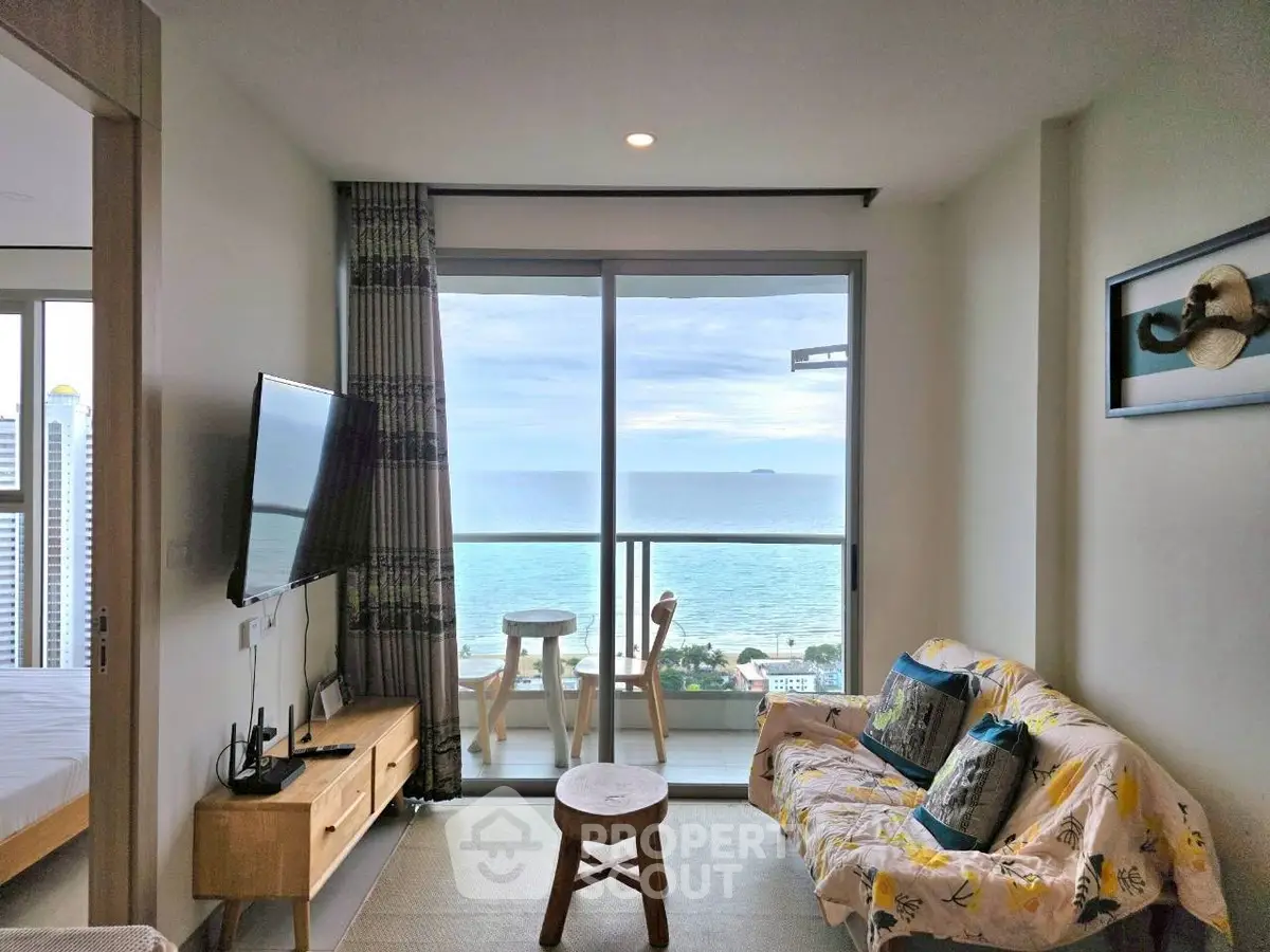 Stunning ocean view from modern living room with stylish decor and large windows.
