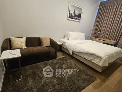 Cozy bedroom with plush sofa and elegant decor, perfect for relaxation and comfort.