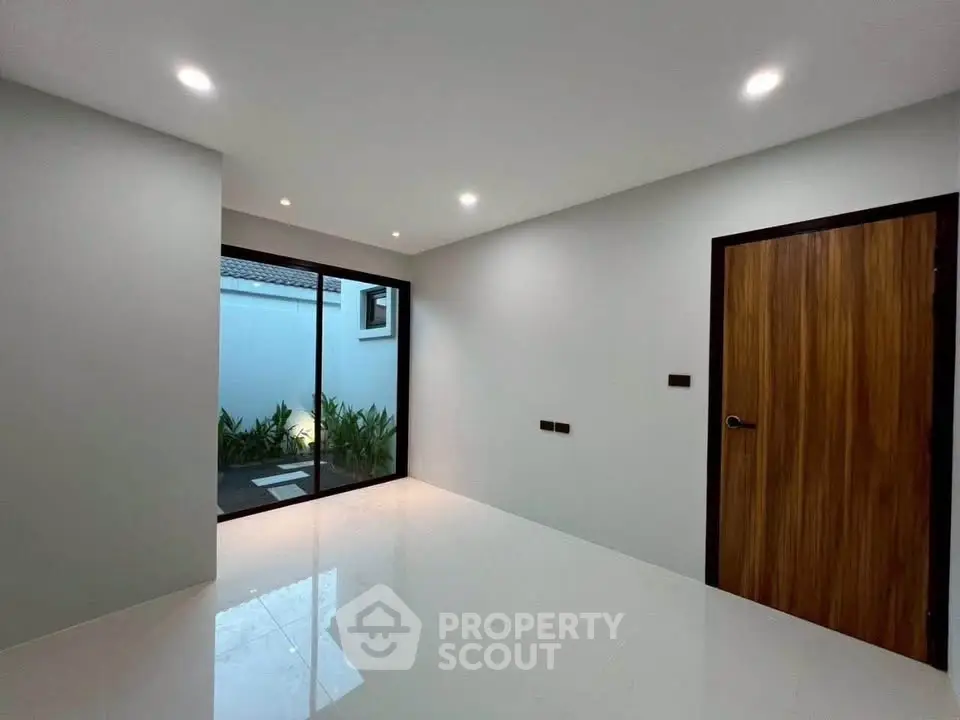 Modern minimalist room with sleek flooring and garden view