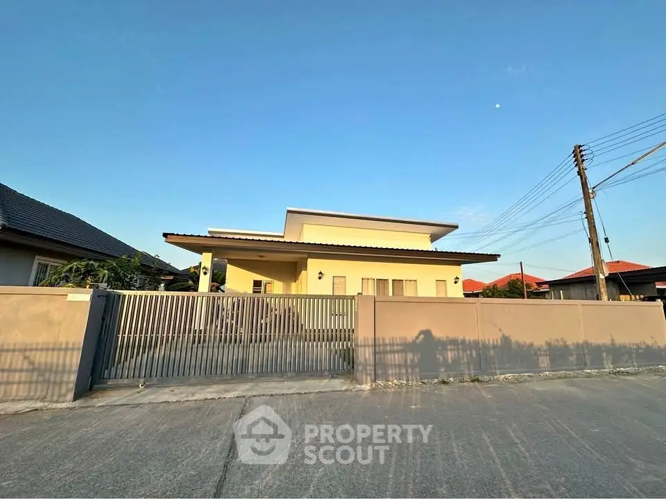 Modern single-story house with sleek design and spacious front yard