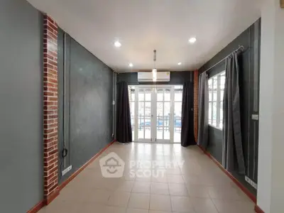 Spacious living room with modern design and large windows for natural light.