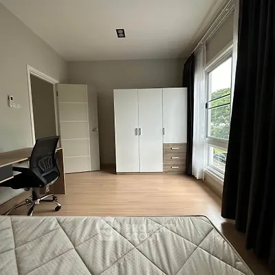 Modern bedroom with large window and sleek furniture design