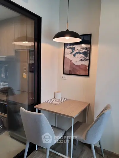 Cozy dining nook with modern decor and stylish lighting in a contemporary apartment.