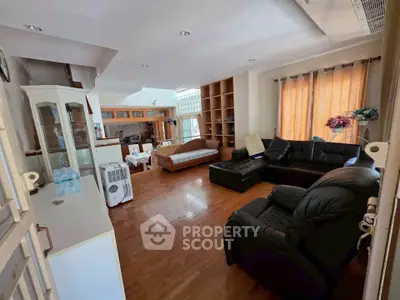 Spacious living room with elegant furniture and wooden flooring