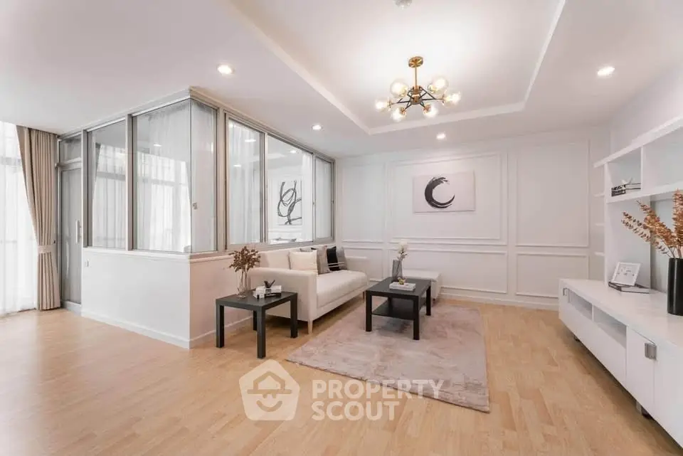 Elegant living room with modern decor and stylish lighting in a spacious apartment.