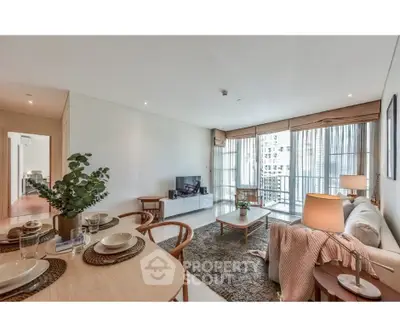 Spacious modern living room with elegant decor and large windows offering city views.