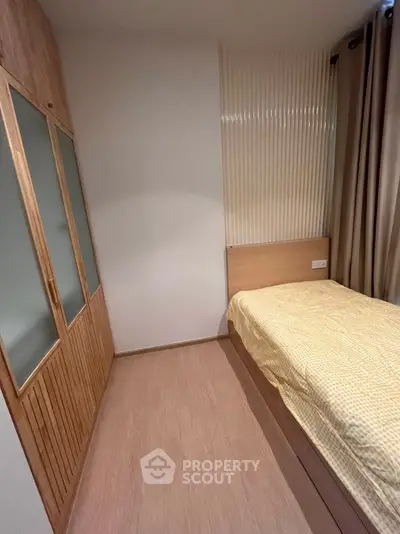 Cozy bedroom with wooden flooring and built-in wardrobe