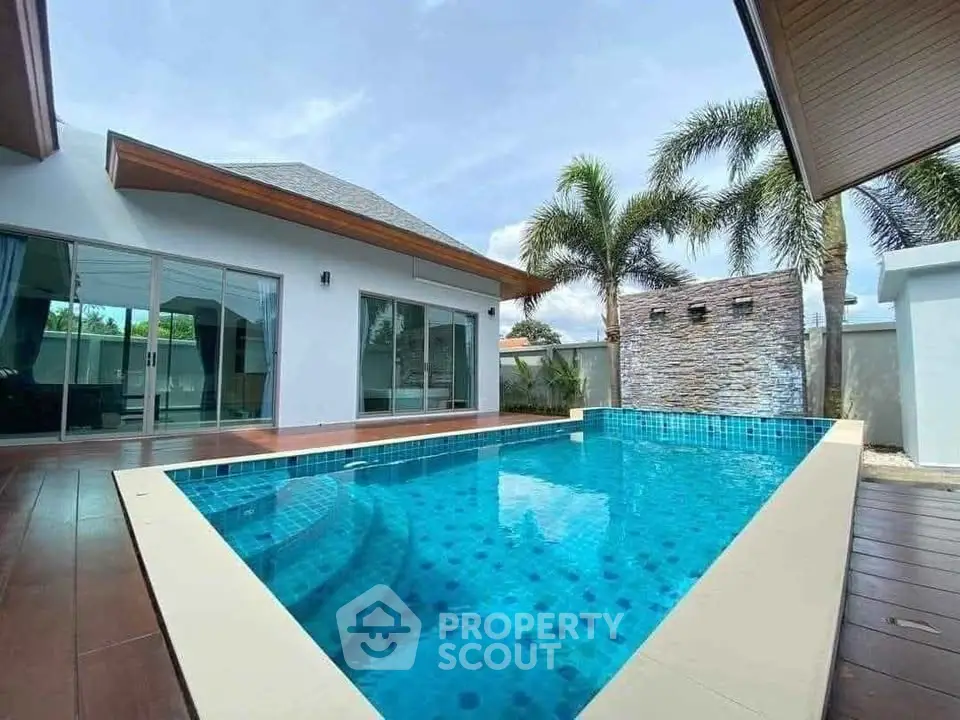 Luxurious modern villa with private pool and palm trees, perfect for tropical living.