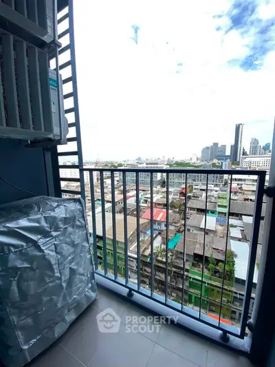 Urban balcony with cityscape view, perfect for enjoying skyline vistas and fresh air in a modern apartment setting.