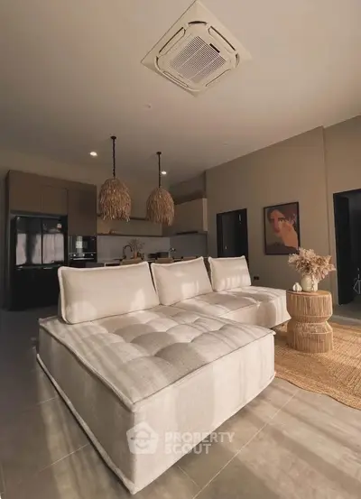 Spacious modern living room with cozy seating and stylish decor, perfect for relaxation and entertaining.