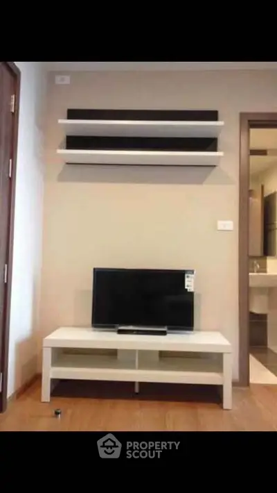 Modern living room with sleek TV stand and wall-mounted shelves