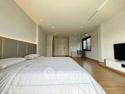 Spacious modern bedroom with sleek design and ample natural light