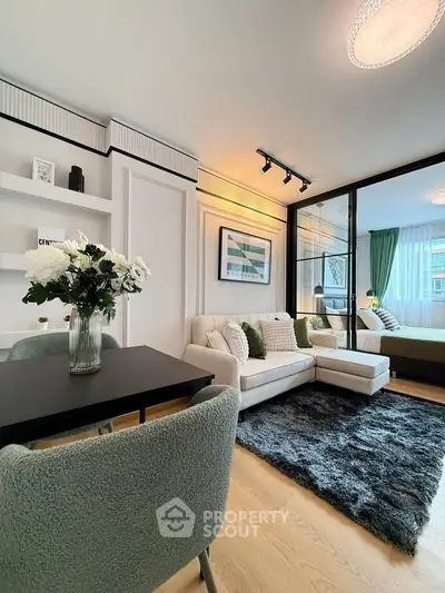 Modern living room with cozy seating and elegant decor in a stylish apartment.