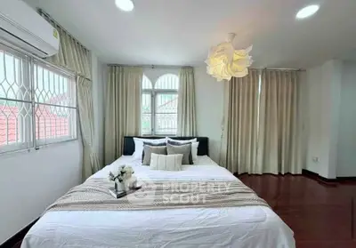 Spacious and elegant bedroom with natural light and modern decor