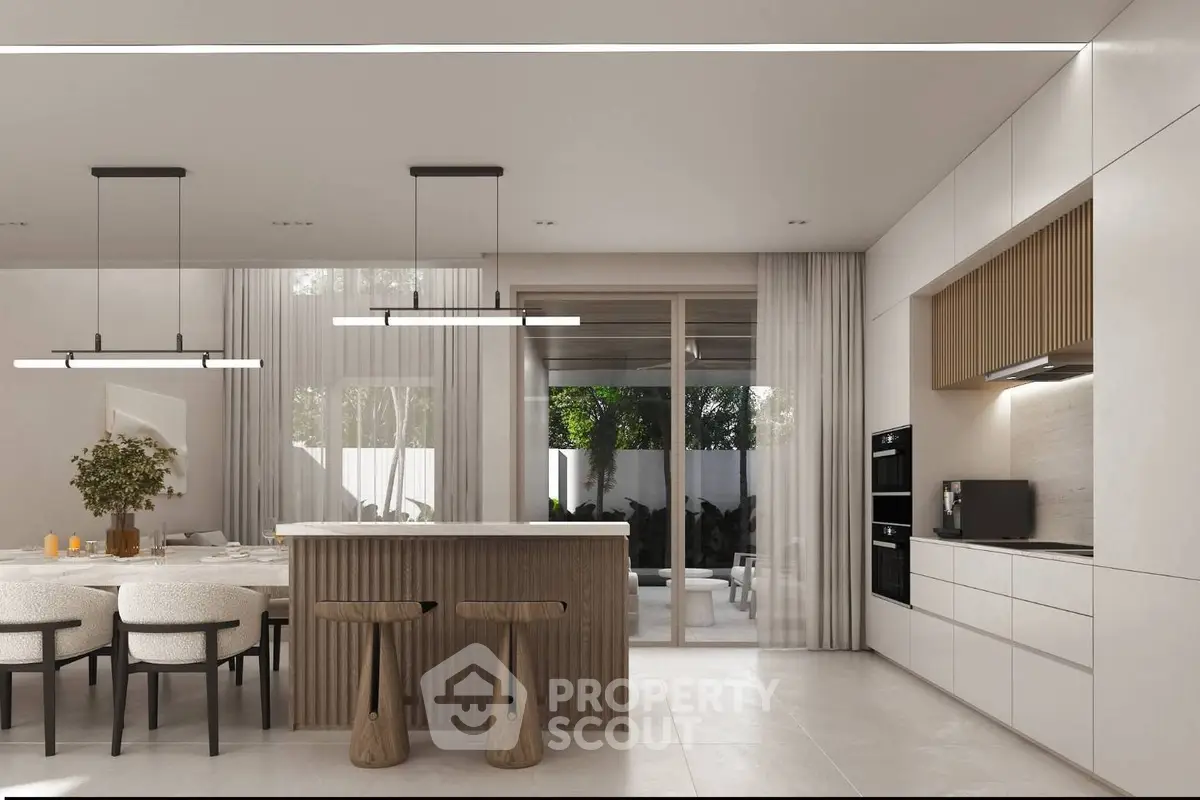 Modern open-layout kitchen with sleek design and dining area, featuring elegant lighting and natural light.