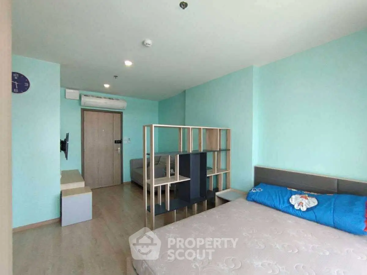 Modern bedroom with stylish partition and cozy decor in a contemporary apartment.