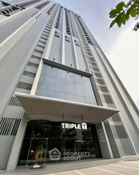 Stunning modern high-rise building entrance with sleek architectural design and glass facade.