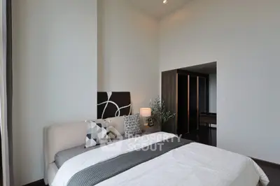 Modern bedroom with stylish decor and ample natural light