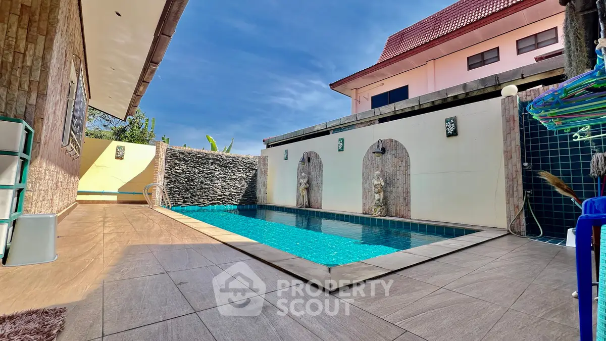 Luxurious private pool area with elegant stone accents and spacious deck, perfect for relaxation and entertainment.