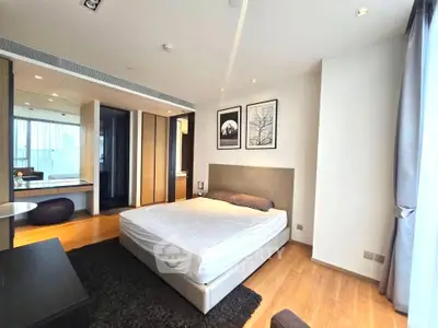 Spacious modern bedroom with large windows and elegant decor in a luxury apartment.