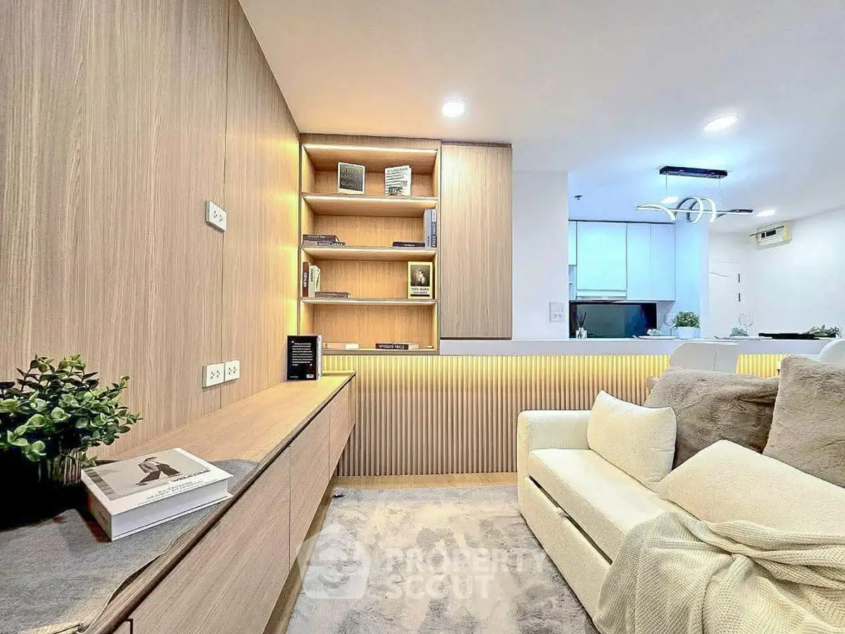 Modern living room with cozy sofa, built-in shelves, and ambient lighting