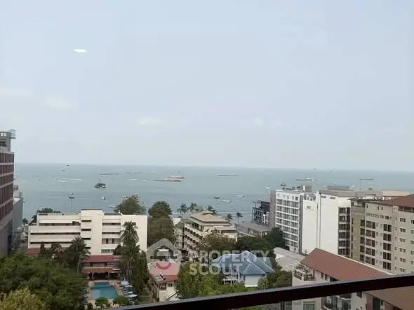 Stunning ocean view from high-rise balcony overlooking cityscape and sea.