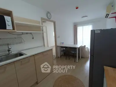 Modern kitchen and dining area with natural light and sleek appliances.