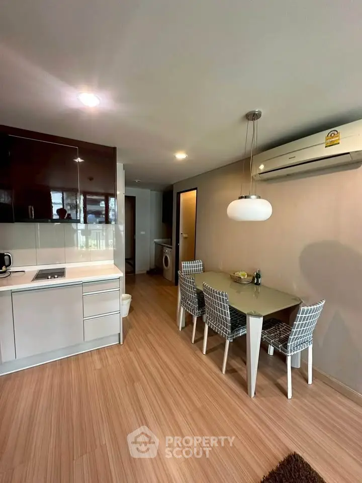 Modern kitchen and dining area with sleek design and wooden flooring