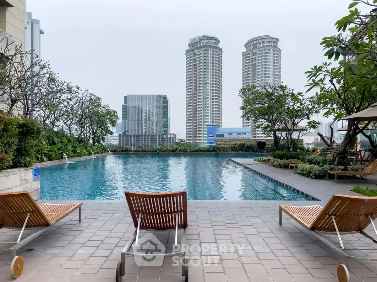 Luxurious rooftop pool with city skyline view and elegant lounge chairs.