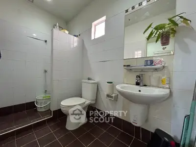 Modern bathroom with sleek white tiles and contemporary fixtures