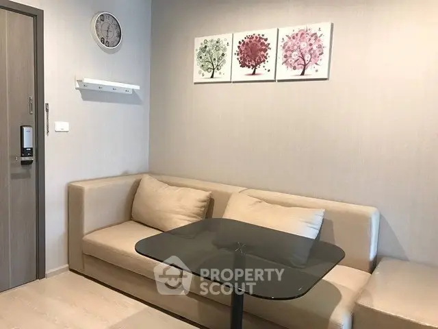 Cozy living room with modern decor and comfortable seating in a stylish apartment.
