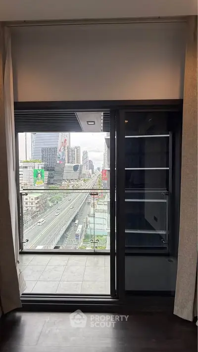 Modern apartment balcony with stunning city view and sliding glass doors