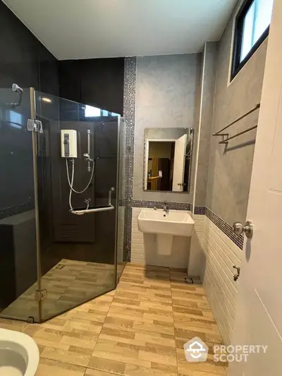 Modern bathroom with glass shower and stylish tile flooring