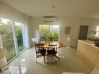 Bright dining area with garden view and modern furnishings
