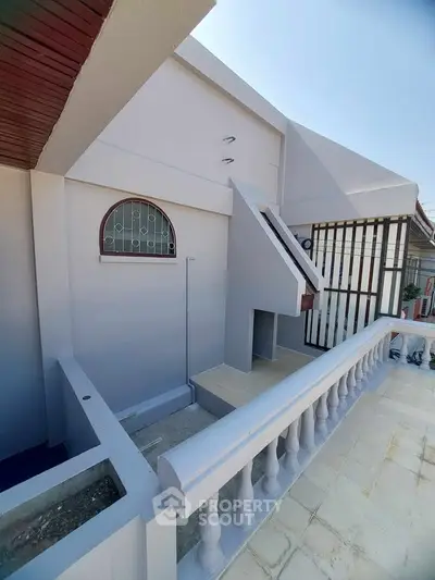 Spacious balcony with modern design and elegant railing in a residential property.