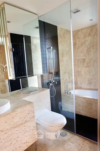 Luxurious modern bathroom with elegant stone tiles and glass shower enclosure