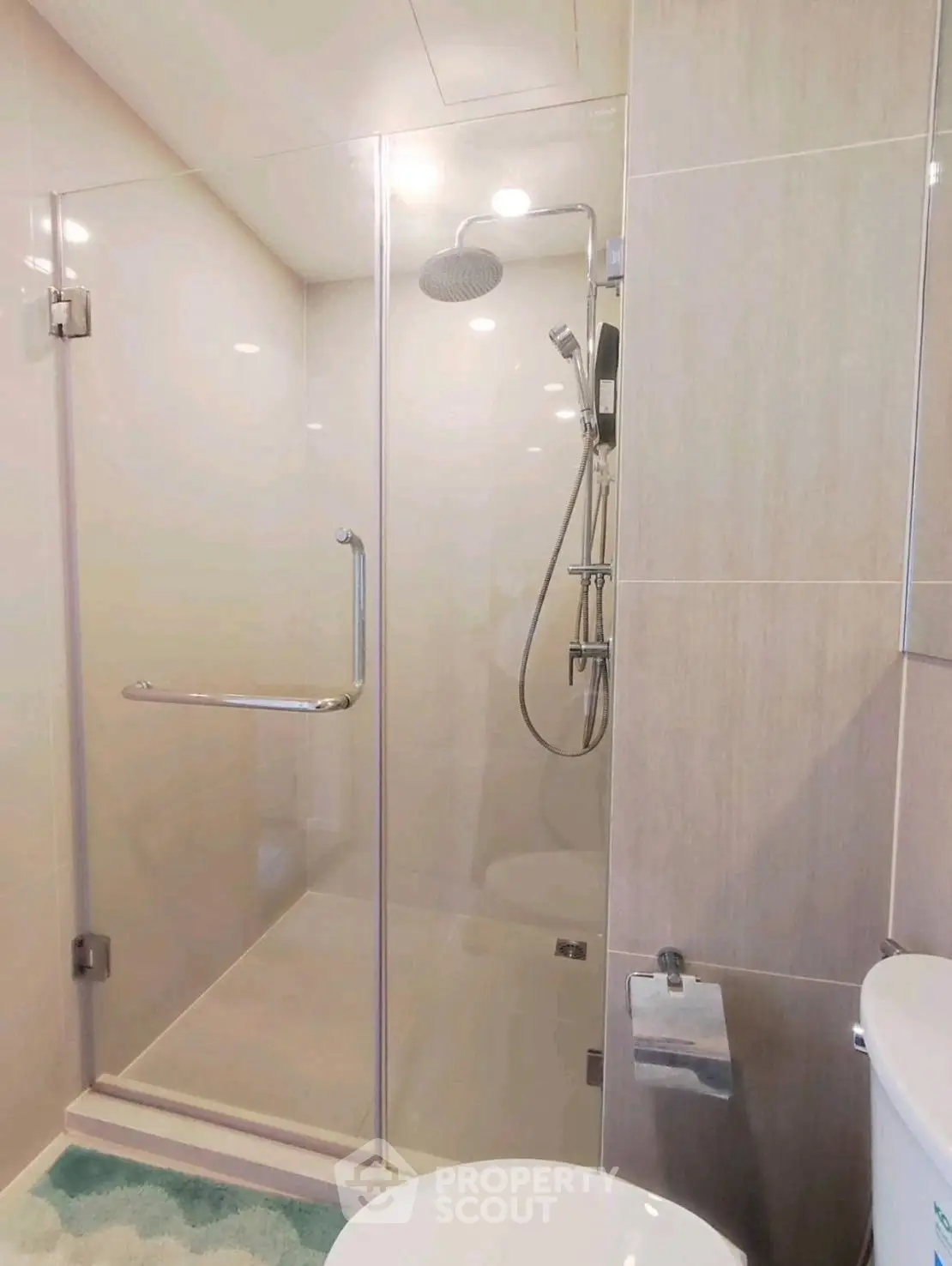 Modern bathroom with glass shower enclosure and sleek fixtures