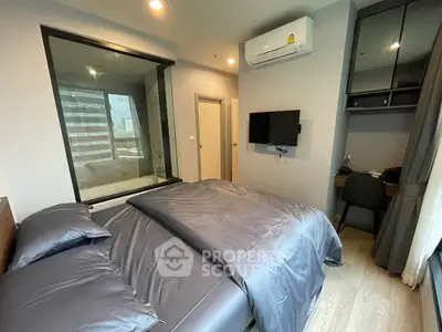 Modern bedroom with city view, featuring sleek design and workspace