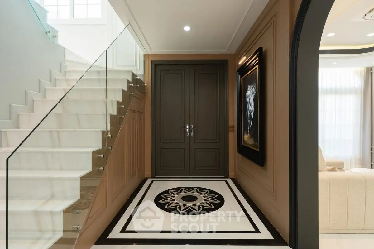 Elegant foyer with modern staircase and stylish decor