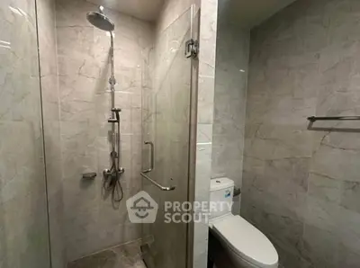 Modern bathroom with glass shower and marble tiles