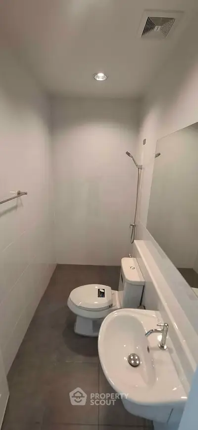 Modern minimalist bathroom with sleek fixtures and neutral tones.