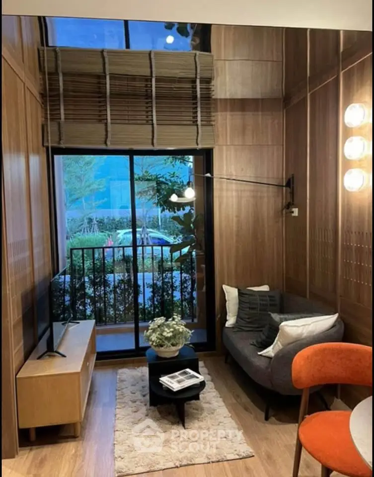 Chic modern living room with floor-to-ceiling windows and stylish decor, perfect for urban living.