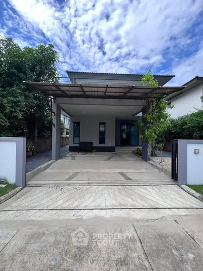 Modern single-story house with sleek driveway and lush greenery, perfect for contemporary living.