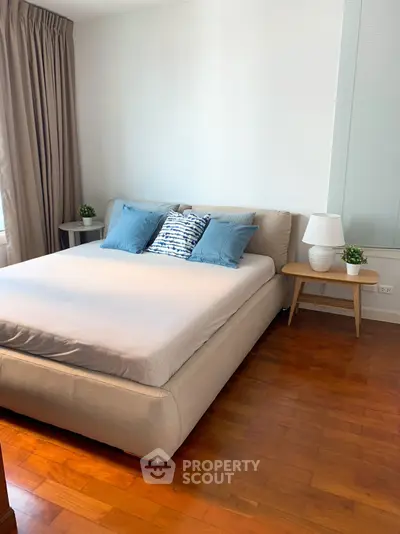 Modern bedroom with cozy bed and stylish decor in a bright apartment.