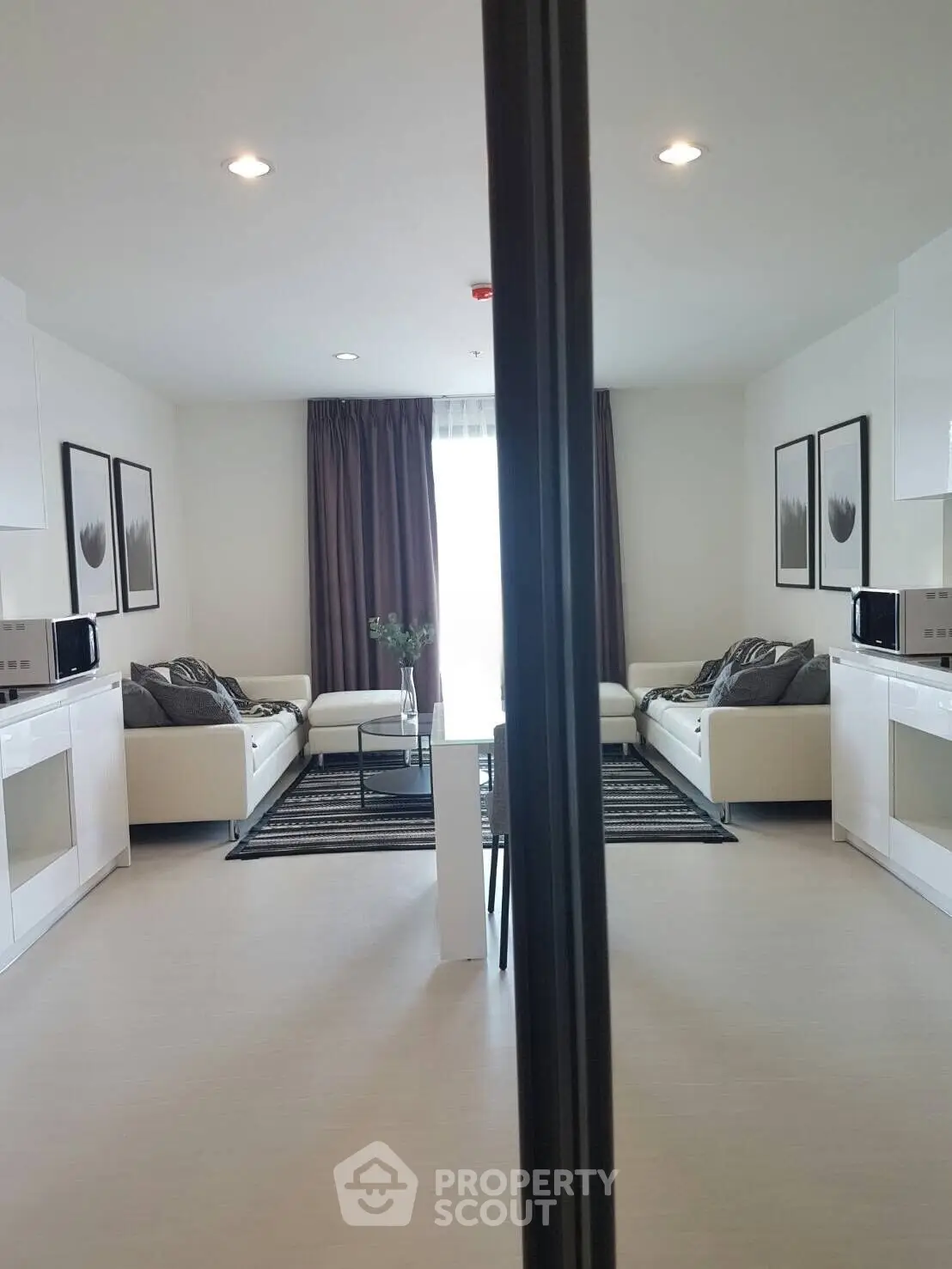 Modern living room with sleek white furniture and stylish decor