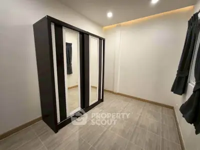 Spacious bedroom with modern wardrobe and elegant lighting