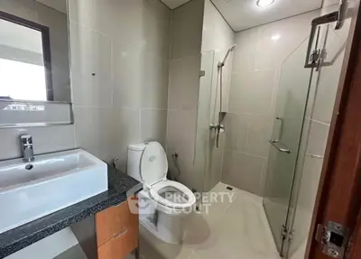 Modern bathroom with sleek fixtures and glass shower enclosure