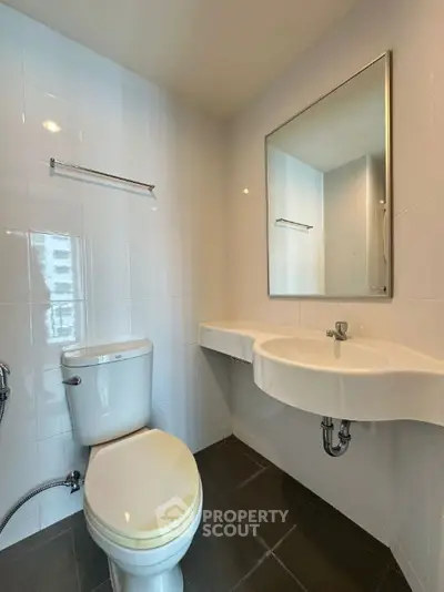 Modern bathroom with sleek fixtures and wall-mounted sink