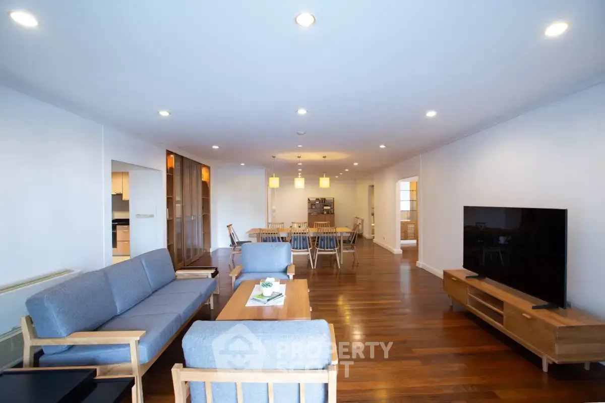 Spacious modern living room with wooden flooring and stylish furniture