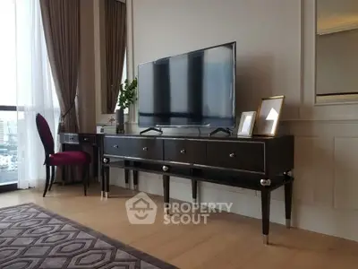 Elegant living room with modern TV stand, large window, and stylish decor in a luxurious apartment.